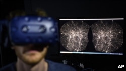 Hadrien Gurnel, software engineer at EPFL's Laboratory for Experimental Museology, explores with a virtual reality headset the most detailed 3D map of the universe with the virtual reality software VIRUP, on Tuesday, Oct. 12, 2021, in St-Sulpice near Laus