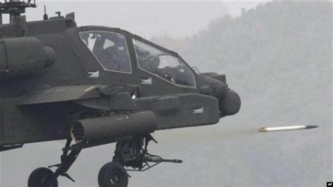 US Apache helicopter fires rocket during joint military exercise between South Korea and United States at US firing Rodriguez Range in Pocheon, south of the demilitarized zone that divides two Koreas, 13 Oct. 2010.
