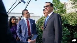 FILE - Treasury Secretary Steven Mnuchin speaks to members of the media at the White House in Washington, July 26, 2018. 