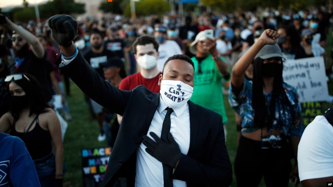 People raise their fists during a rally, June 5, 2020, in Las Vegas, against police brutality sparked by the death of George Floyd.
