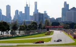 FILE - Formula One cars race on the circuit during the final practice session for the Australian Grand Prix in Melbourne, Australia, March 16, 2019. The 2021 Australian Grand Prix has been canceled amid COVID-19 fears.