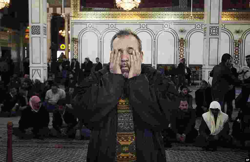 A man reacts at a funeral of the victims of a bombing attack in Damascus, Syria, March 18, 2012. (AP)