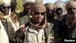 FILE - The son of Chad's late president Idriss Deby, Mahamat Idriss Deby Itno (also known as Mahamat Kaka) and Chadian army officers gather in the northeastern town of Kidal, Mali, Feb. 7, 2013. 