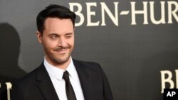 Jack Huston, the star of "Ben-Hur," winks at photographers at the premiere of the film at the TCL Chinese Theater IMAX, Aug. 16, 2016, in Los Angeles.