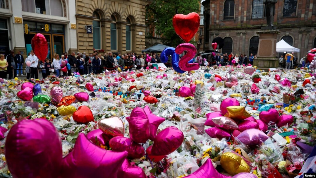FILE - Flowers and tributes to the victims of the attack on Manchester Arena fill St Ann's Square in Manchester, Britain, May 29, 2017. Some are trying to scam free tickets to a benefit for the victims.