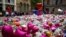 FILE - Flowers and tributes to the victims of the attack on Manchester Arena fill St Ann's Square in Manchester, Britain, May 29, 2017. Some are trying to scam free tickets to a benefit for the victims.