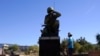 A visitor looks up at the Navajo Code Talkers Memorial on Veterans Day, Nov. 11, 2020, in Phoenix, Arizona. John Kinsel Sr., one of the last remaining Navajo Code Talkers who transmitted messages during World War II based on the tribe's native language, has died at 107. 