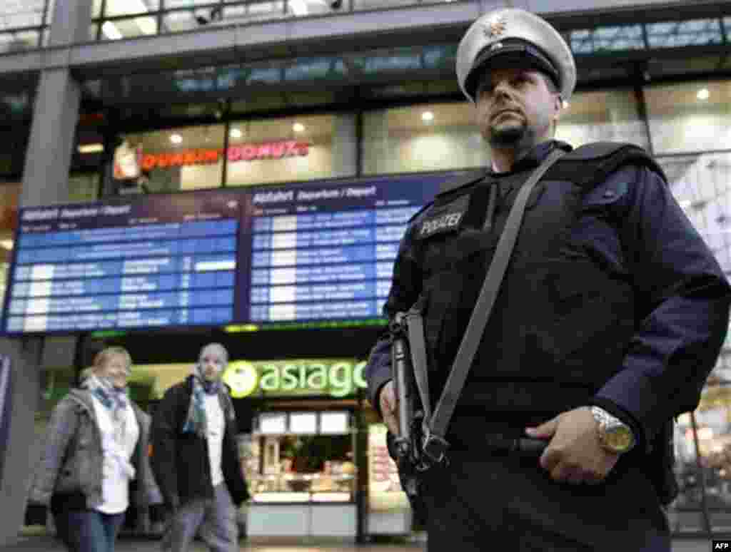 A police officer wearing a bulletproof vest stands guard at the main train station in Berlin, Germany, Wednesday, Nov. 17, 2010. Germany's interior minister announced Wednesday that he is ordering increased security in the country in light of a heightened