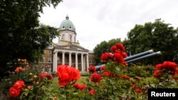 FILE - Roses bloom outside the Imperial War Museum in central London. A new exhibition on display is “Lee Miller: A Woman’s War”, ends on April 24, 2016.