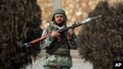 A national army soldier stands guard at the site of a clash between gunmen and security forces in Kabul, Afghanistan, Dec. 18, 2017. 