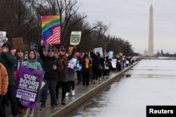 Protesters attend the People's March on the Washington Mall on Jan. 18, 2025, ahead of the inauguration of U.S. President-elect Donald Trump.