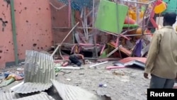 FILE: A man crouches to inspect a damaged playground following an air strike in Mekele, the capital of Ethiopia's northern Tigray region, August 26, 2022 in this still image taken from video. Tigray TV/Reuters TV via REUTERS