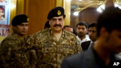 FILE - Pakistan's Army Chief General Raheel Sharif is seen arriving at a seminar in Gwadar, a town about 700 kilometers (435 miles) west of Karachi, Pakistan, April 12, 2016. On Thursday Sharif reportedly dismissed 11 top officers for corruption.