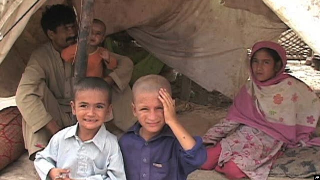 These Pakistani flood victims have set up camp near a busy roadway
