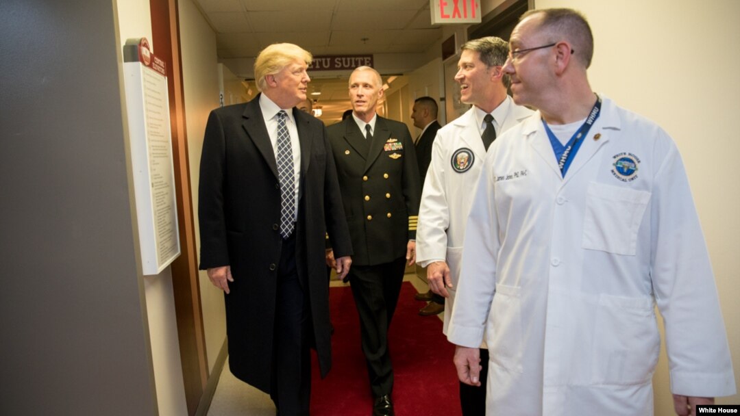 President Donald J. Trump talks with, from left to right, with Capt. Mark Kobelja, director of Walter Reed National Military Medical Center; Dr. Ronny Jackson, physician to the president; and Dr. James Jones, physician to the president and medical director of the Medical Evaluation and Treatment Unit, Jan. 12, 2018, in Bethesda, Md., following the president’s annual physical at the medical facility. 