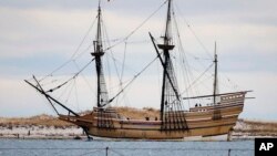 FILE - In this Dec. 12, 2014 file photo, the Mayflower II, a replica of the original ship that brought Pilgrims to Massachusetts in 1620, passes a jetty as it is towed out of Plymouth Harbor in Plymouth, Mass.