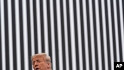 President Donald Trump speaks near a section of the U.S.-Mexico border wall, Jan. 12, 2021, in Alamo, Texas. 