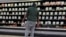 A shopper checks out nearly empty shelves in the lunch meat section of a Walmart,  Sept. 25, 2024 in Tallahassee, Florida. A nationwide recall of meat and poultry products potentially contaminated with listeria has expanded to nearly 12 million pounds, Oct. 16, 2024. 