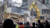 Rescuers use an excavator as they search for victims at the site of an Israeli airstrike that hit a building in Beirut on Nov. 26, 2024.