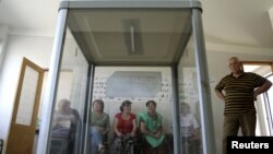 Election commission officials prepare a polling station on the eve of the parliamentary election in Tbilisi, September 30, 2012.