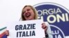 FILE - Leader of Brothers of Italy Giorgia Meloni holds a sign at the party's election night headquarters, in Rome, Italy September 26, 2022.