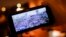 FILE - A man looks at Telegram channel NEXTA Live on his smartphone showning a rally against President Alexander Lukashenko, in Minsk, Belarus, Aug. 19, 2020. 
