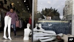 Israeli retailer cleans up after rocket from Gaza Strip lands nearby in Ashdod, March 13, 2012.