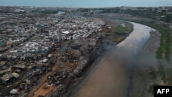 FILE - This aerial view shows a dump site where secondhand clothes are discarded at Old Fadama in Accra, Ghana, on November 15, 2023.