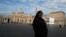 A nun stands in front of St. Peter's Basilica at the Vatican, February 12, 2013.