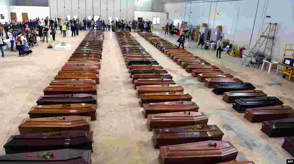 Coffins of victims are seen in an hangar of Lampedusa airport, Oct. 5, 2013, after a boat with migrants sank killing more than 100 people. Italian emergency services hoped to resume the search for bodies despite rough seas after the accident, in which 111 African asylum-seekers are confirmed dead and around 200 more are still missing.