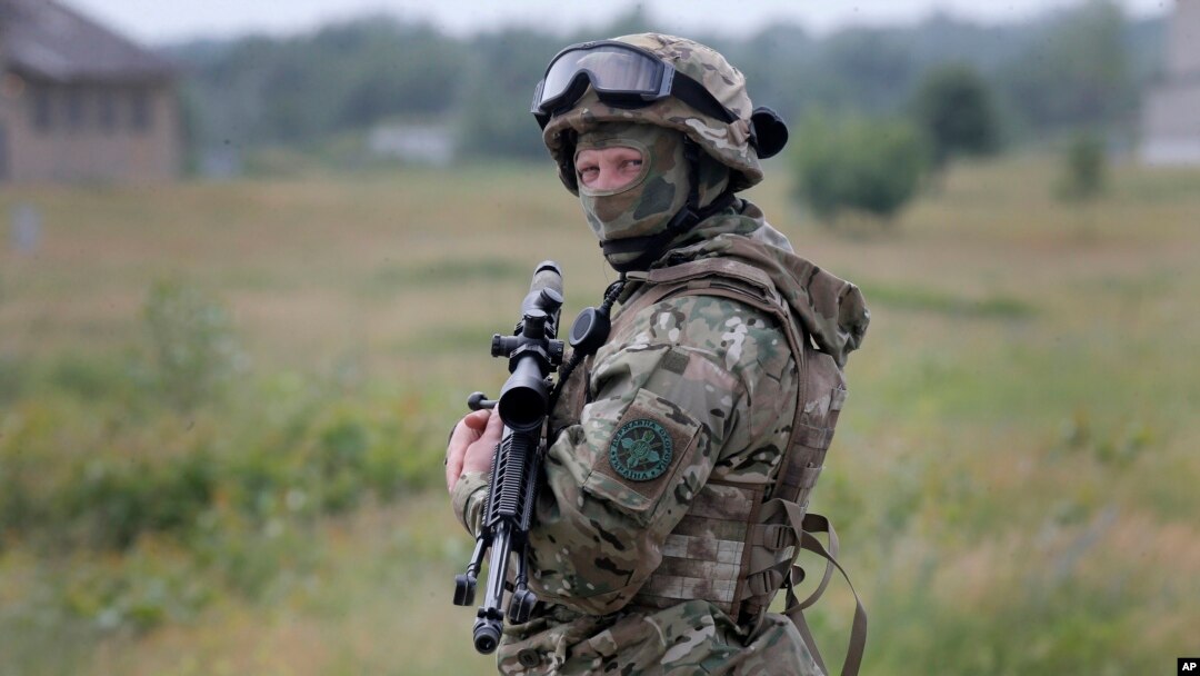 FILE - A Ukrainian soldier stands during training in a landfill at Chuguev, Ukraine, June 4, 2014.