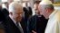 Pope Francis talks to Palestinian President Mahmoud Abbas (L) during a private audience in the pontiff library at the Vatican, Oct. 17, 2013. 