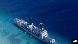 FILE - In photo provided by the Armed Forces of the Philippines, Aug. 29, 2018, shows the Philippine Navy ship BRP Gregorio del Pilar after it ran aground during a routine patrol in the vicinity of Half Moon Shoal, which is called Hasa Hasa in the Philipp