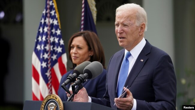 U.S. President Joe Biden, accompanied by Vice President Kamala Harris, speaks about the coronavirus disease (COVID-19) response and the vaccination program from the Rose Garden of the White House in Washington, U.S., May 13, 2021. REUTERS/Kevin Lamarque