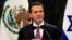 FILE - Mexico's President Enrique Pena Nieto gives a speech next to Israel's President Shimon Peres (not pictured) during a news conference after an official welcoming ceremony for Peres at Los Pinos presidential residence in Mexico City, Nov. 27, 2013. 
