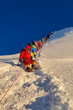 This photo taken May 12, 2021, shows mountaineers climbing during their ascent to summit Mount Everest, in Nepal. (Pemba Dorje Sherpa)
