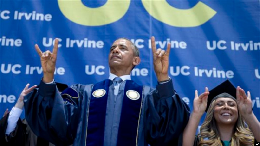 President Barack Obama and student Jacqueline Rodriguez flash the symbol of the school mascot "Anteaters" of the University of California, Irvine, in Anaheim, June 14, 2014.