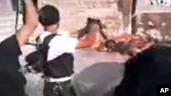 This image made from amateur video released by Tabshoor1 and accessed July 31, 2012, purports to show Free Syrian Army soldiers executing Assad loyalists in Aleppo, Syria. THE ASSOCIATED PRESS IS UNABLE TO INDEPENDENTLY VERIFY THE AUTHENTICITY, CONTENT, 