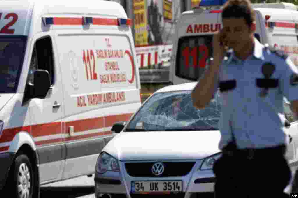 A police officer talks on his mobile phone following a blast in Istanbul May 26, 2011. A bomb placed on an electric bicycle exploded in Istanbul on Thursday, wounding seven people, Istanbul's police chief Huseyin Capkin told reporters. He said none of the