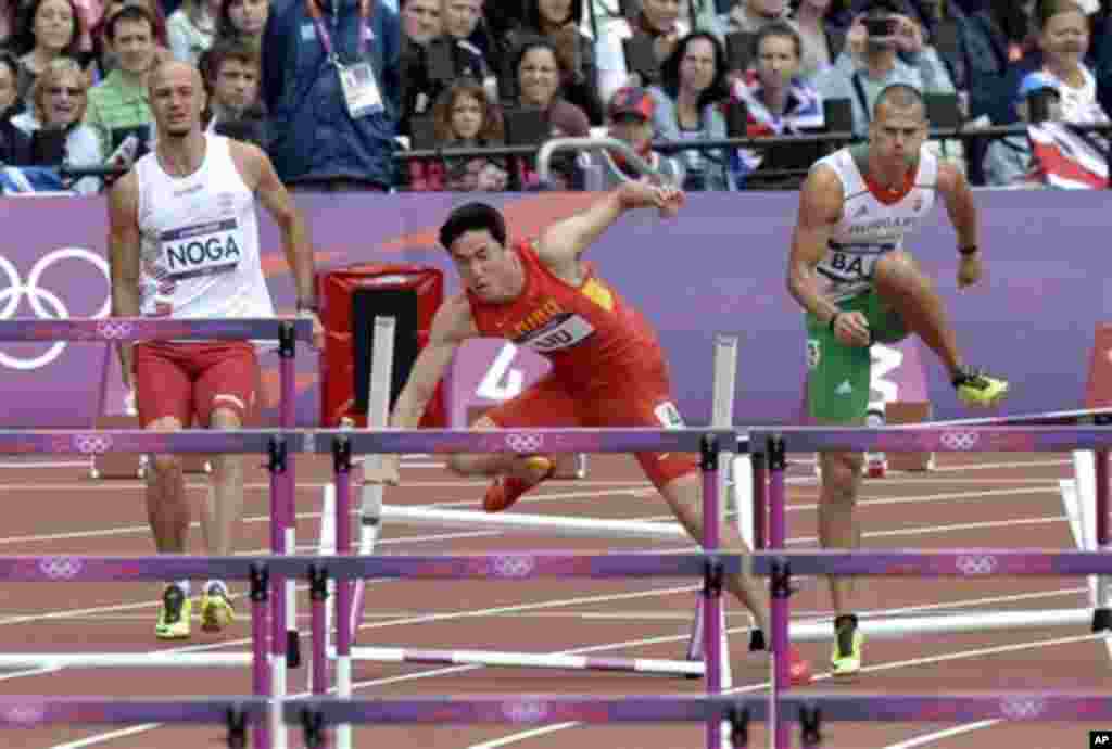 China's Liu Xiang, second left, falls as Hungary's Balazs Baji, left, and Poland's Artur Noga, right, react duing a men's 110-meter hurdles heat during the athletics in the Olympic Stadium at the 2012 Summer Olympics, London, Tuesday, Aug. 7, 2012. (AP P