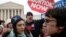 FILE - A pro-choice supporter is confronted by pro-life supporters at a rally in front of the U.S. Supreme Court in Washington, Jan. 22, 2007.