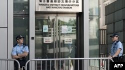 Policemen stand in front of the police headquarters where organizers of Hong Kong's biggest pro-democracy rally were arrested in Hong Kong, July 4, 2014. 