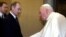 Pope John Paul II and Russian President Vladimir Putin shake hands at the Vatican, June 5, 2000.
