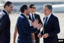 FILE — Cyprus' President Nikos Christodoulides (C) and Foreign Minister Constantinos Kombos (L) welcome US Secretary of State Antony Blinken (R) at Larnaca airport on November 5, 2023, ahead of talks on the ongoing battles between Israel and Hamas.