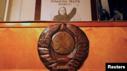 FILE - Posters and symbols decorate the walls of Stalin's Bunker, a complex built in 1942 as an alternative headquarters for the Soviet Union leader Joseph Stalin, in Samara, Russia, July 4, 2018. 