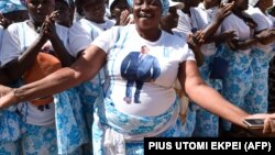 Des femmes chantent des slogans soutenant le président togolais Faure Gnassingbe durant un meeting de campagne à Dapaong, dans le nord du Togo, le 16 février 2020. (Photo by PIUS UTOMI EKPEI / AFP)