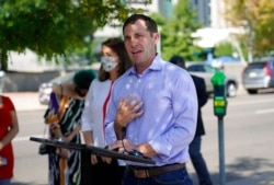 FILE - U.S. Rep. Jason Crow, D-Colo., speaks during a news conference in Denver, Aug. 18, 2020.