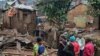 People stand by the damage in the aftermath of deadly floods caused by torrential rains in Bukavu, Democratic Republic of Congo, December 27, 2023. 