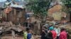 People stand by the damage in the aftermath of deadly floods caused by torrential rains in Bukavu, Democratic Republic of Congo, December 27, 2023.