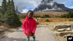 In this photo provided by Ben Pascal, five-year-old Naomi Pascal, holding her teddy bear, is pictured on a hike to Hidden Lake in Glacier National Park, Montana, in October 2020.